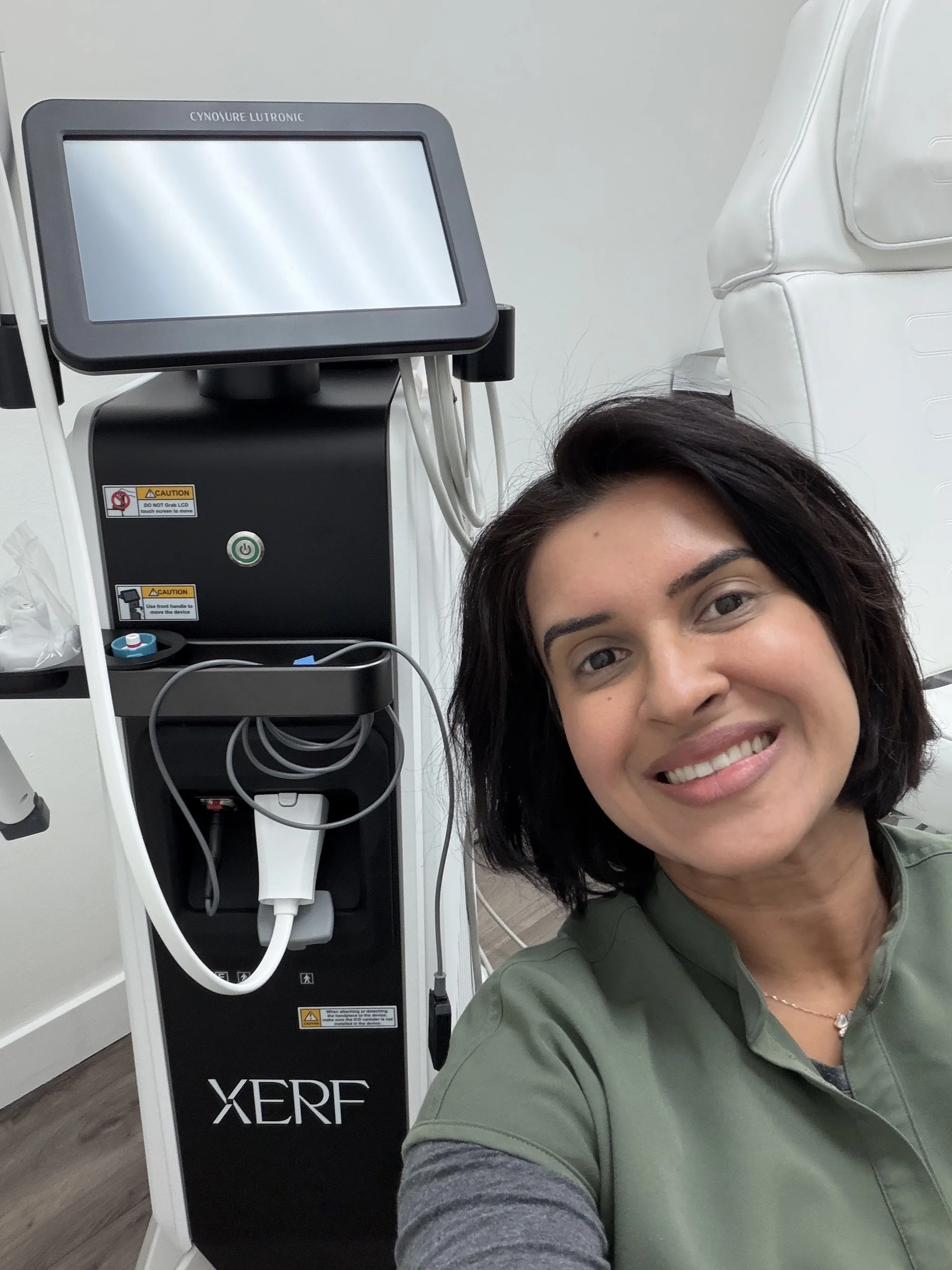 Dr. Inderpreet Sanghera smiling beside the XERF device in a treatment room