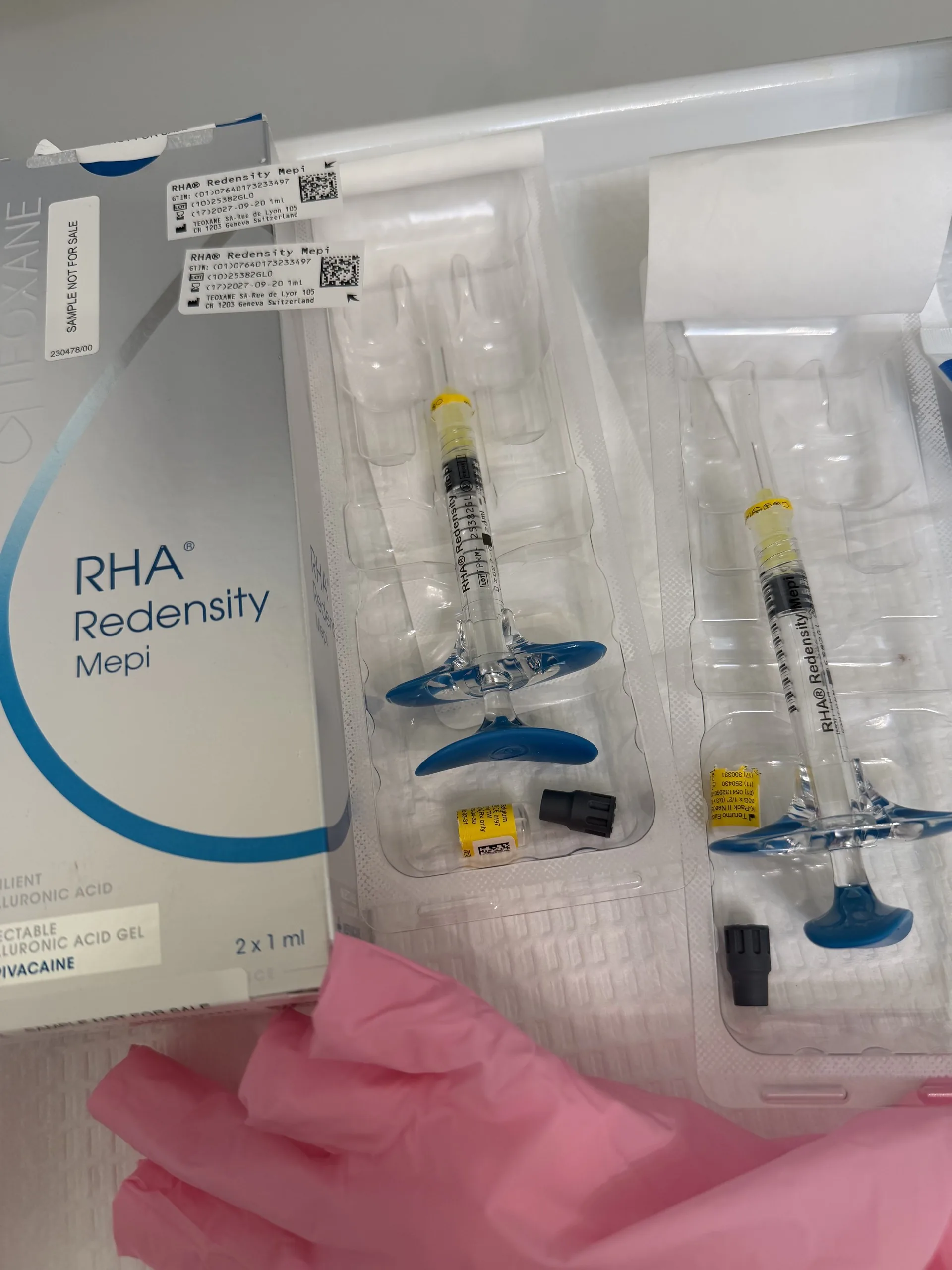 An RHA Redensity filler box and two prefilled syringes on a treatment tray