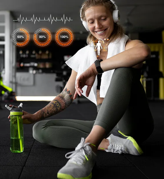 A smiling woman sitting on a gym floor with a water bottle, checking her fitness watch, with heart rate graphics overlaid