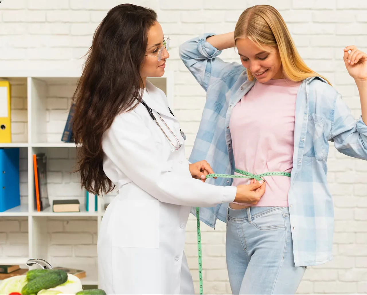 A doctor in a white coat measuring a smiling woman’s waist with a tape measure